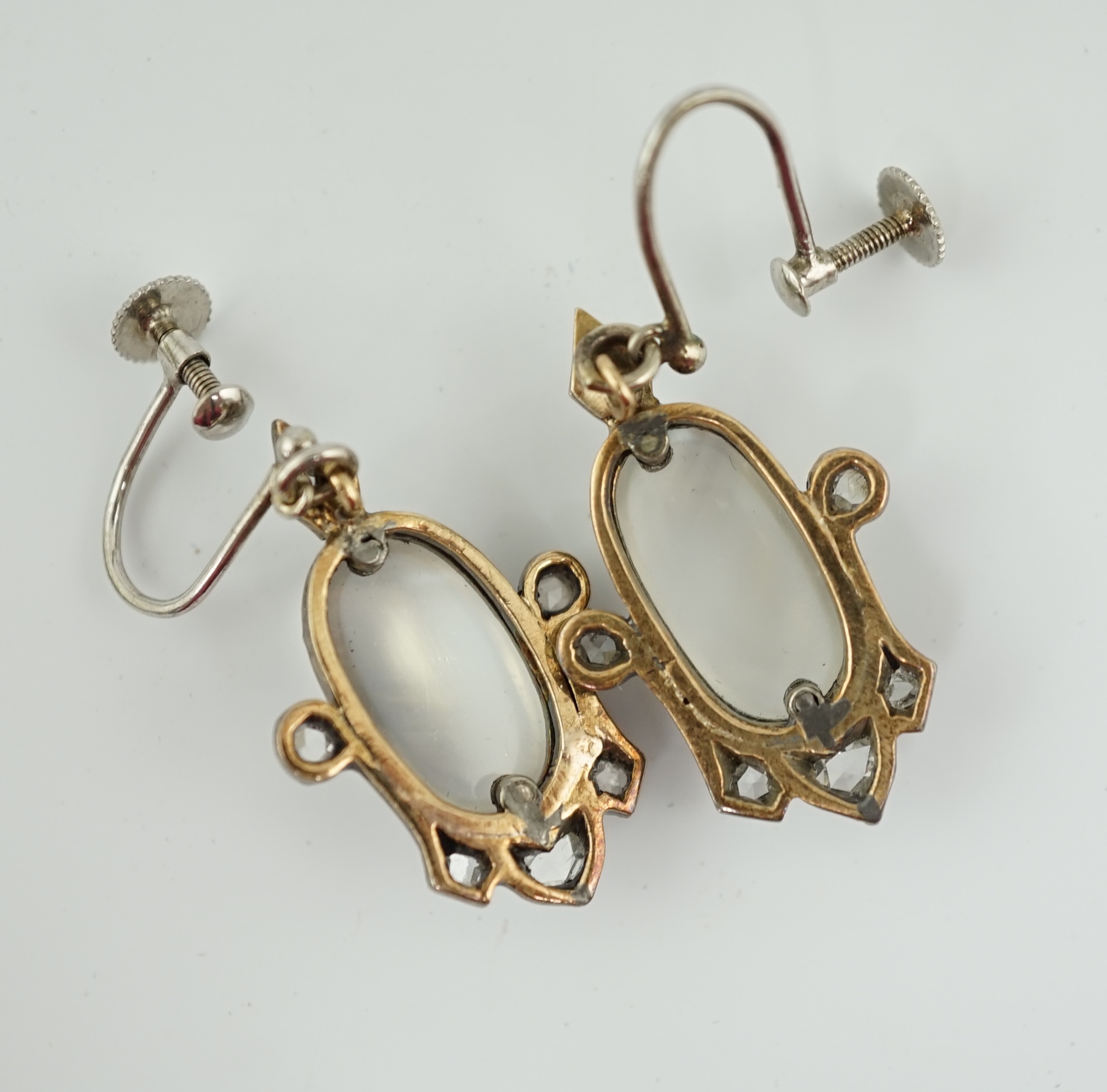 A pair of early 19th century gold and silver, cabochon moonstone and rose cut diamond cluster set drop ear clips